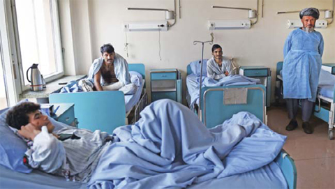 Wounded Afghan National Army (ANA) soldiers sit on beds on a ward at Sardar Mohammed Daoud Khan Military Hospital in Kabul. — AFP photos