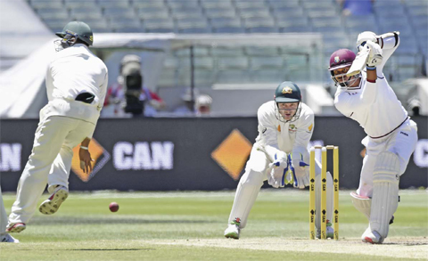 MELBOURNE: Australia’s Usman Khawaja, left, avoids a shot from West Indies’ Marlon Samuels, right, during their cricket test match in Melbourne, Australia, yesterday. — AP