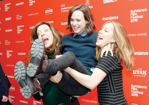 Actress Allison Janney, left, and director and writer Sian Heder, right, pick up and swing actress Ellen Page, center, as they pose at the premiere of “Tallulah” during the 2016 Sundance Film Festival .— AP
