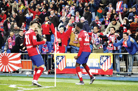 MADRID: Atletico’s Thomas Partey, right, celebrates after scoring a goal during a Spanish La Liga soccer match between Atletico de Madrid and Levante at the Vicente Calderon stadium in Madrid, Spain, Saturday. —AP