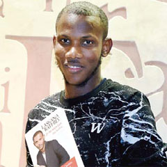 PARIS: Lassana Bathily - the employee of the Hyper Cacher Jewish supermarket in Paris who helped shoppers hide in a cold storage room from an Islamist gunman who attacked the store on January 9, 2015, poses with his book “Je ne suis pas un heros” (I Am Not A Hero). — AFP