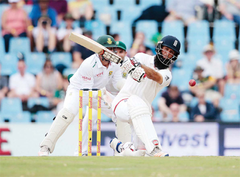 England’s batsman Moeen Ali (right) plays a shot during day 3 of the fourth Test match between England and South Africa at Supersport stadium. — AFP