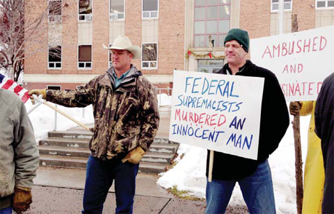 Protesters stand in front of the Harney County Courthouse.