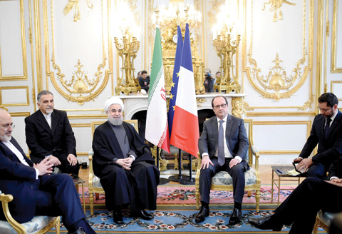 PARIS: French President Francois Hollande (right) meets with Iranian President Hassan Rouhani (3rd L) yesterday at the Elysee presidential Palace in Paris. — AFP