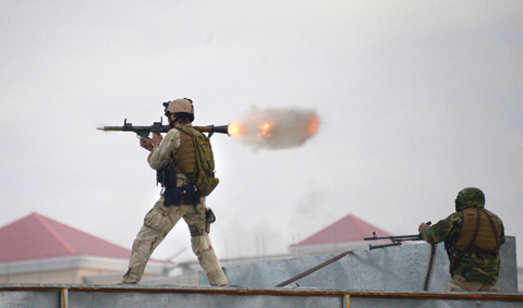 MAZAR-I-SHARIF: An Afghan Quick Reaction Force (QRF) soldier fires a rocket-propelled grenade (RPG) launcher during an operation near the Indian consulate in Mazar-i-Sharif yesterday. — AFP