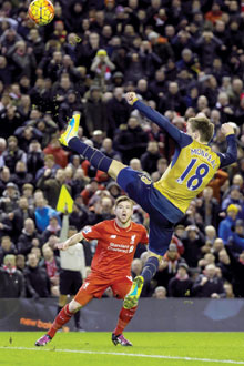 LIVERPOOL: Arsenal’s Nacho Monreal (right) clears the ball away from Liverpool’s Alberto Moreno during the English Premier League soccer match between Liverpool and Arsenal at Anfield Stadium on Wednesday, Jan 13, 2016. — AP
