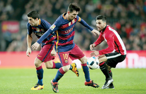 BARCELONA: FC Barcelona's Lionel Messi, center, duels for the ball against Athletic Bilbao's Eneko Boveda during quarterfinal, second leg,nCopa del Rey soccer match at the Camp Nou stadium in Barcelona, Spain, Wednesday. - AP