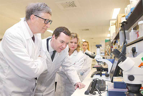 Bill Gates (left), co-founder of Microsoft, Britain’s Finance Minister George Osborne (second left) and Britain’s Secretary of State for International Development, Justine Greening (third left), are pictured during a visit to the Liverpool School of Tropical Medicine in northwest England yesterday. —AFP photos