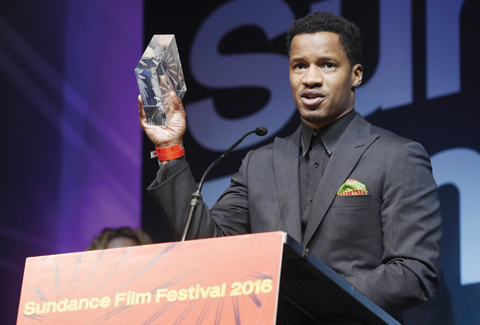 Nate Parker, the star, director and producer of “The Birth of a Nation,” holds aloft the US Dramatic Audience Award for the film during the 2016 Sundance Film Festival Awards Ceremony. —AP photos