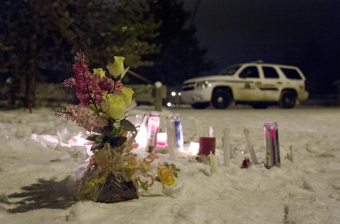 SASKATCHEWAN: Candles and flowers placed as a memorial lay near the La Loche junior and senior high school as police investigate the scene of a daytime shooting at the school yesterday. - AP 