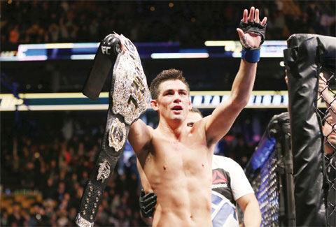 BOSTON: Dominick Cruz celebrates with the title belt after his win against TJ Dillashaw in a UFC bantamweight title match on Sunday, Jan 17, 2016. — AP