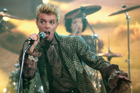 A photo taken on February 22, 1997 shows British rock music legend David Bowie performing on stage during the German TV program “Wetten, da?...?” in M¸nster, western Germany.