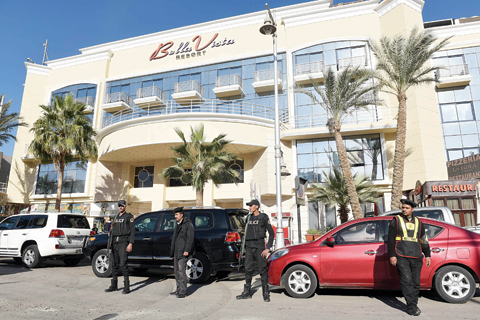 HURGHADA: Egyptian police and security stand guard in front of the Bella Vista Hotel in this Red Sea resort yesterday, a day after the hotel came under attack by knife-wielding assailants. —AFP