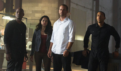 This photo provided by Universal Pictures shows, from left, Tyrese Gibson as Roman, Michelle Rodriguez as Letty, Paul Walker as Brian, and Chris Ludacris as Tej, in a scene from ‘Furious 7.’ — AP