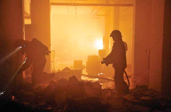 Firefighters tackle a blaze at a basement of a building in Farwaniya