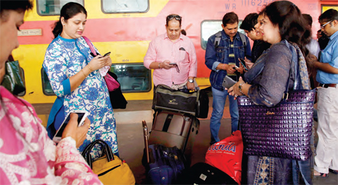 MUMBAI: Indian travellers use a free WiFi service to browse the net at Mumbai Central Train Station in Mumbai on Friday. Google Inc has begun offering free WiFi to Mumbai train passengers in hopes of boosting its role in the Indian market, the first of 400 stations the company plans to eventually reach with the service. — AP