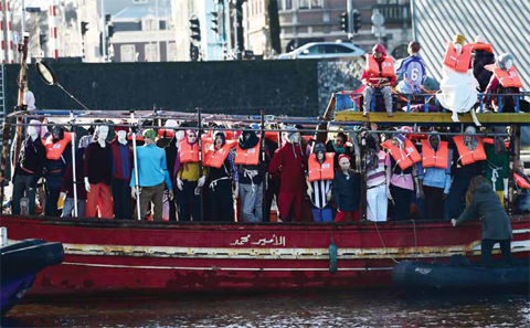 AMSTERDAM: Amnesty International activists hold a protest against the ongoing migrant crisis with a boat filled with mannequins wearing life vests outside the Maritime Museum in Amsterdam, during an informal meeting of EU Justice and Home Affairs ministers at the Maritime Museum. —AFP
