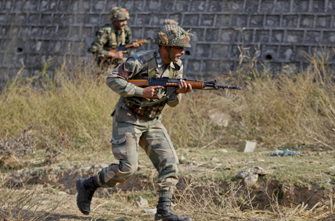 PATHANKOT: Indian army soldiers conduct a search operation in a forest area outside the Pathankot air force base yesterday. — AP
