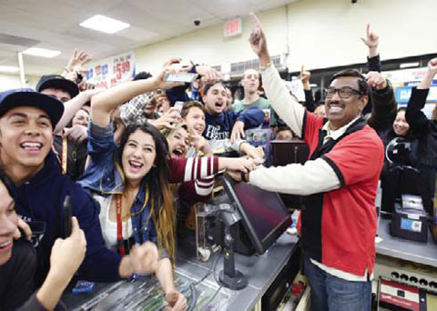 7-Eleven store clerk M Faroqui celebrates with customers after learning the store sold a winning Powerball ticket on Wednesday in Chino Hills, Calif.—AP