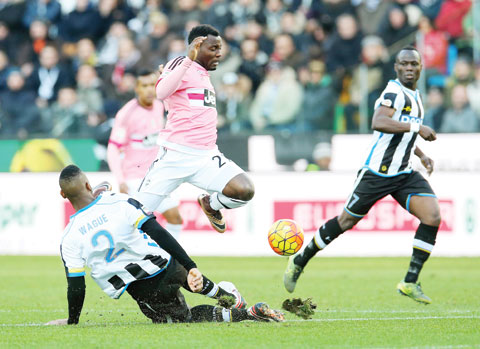 UDINE: Juventus’s Kwadwo Asamoah, center, and Udinese's Molla Wague, left, challenge for the ball during the Serie A soccer matchnbetween Udinese and Juventus at the Friuli Stadium in Udine,Italy, yesterday. – APn