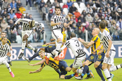 TURIN: Juventus' Alvaro Morata, center, jumps for the ball during a Serie A soccer match between Juventus and Verona at the Juventus stadium, in Turin, Italy, yesterday. - AP