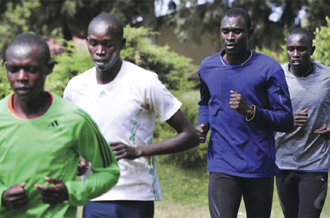 NAIROBI: Kenya’s 800m world record Olympic champion David Rudisha (2nd-R) and other Kenyan athletes run during a training session in Iten in the Rift Valley, 329 kms north of Nairobi, yesterday. — AFP