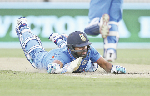 CANBERRA: Indian batsman Rohit Sharma dives into his crease as the ball bounces in front of him during their One Day International cricket match against Australia in Canberra, Australia yesterday. — AP