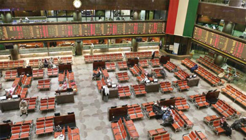 KUWAIT: Traders follow stock market activity at the Kuwait Stock Exchange yesterday. — Photo by Yasser Al-Zayyat