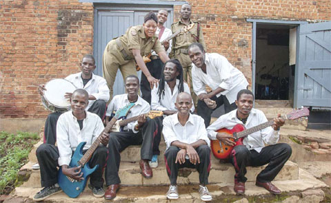 Members of Malawi’s Zomba prison project band pose for a photograph outside the Central Prison’s makeshift music studio at the end of a rehearsal.