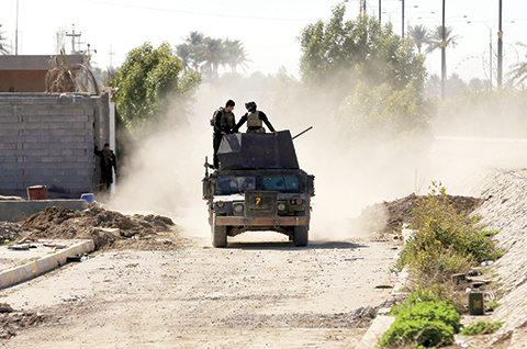 Iraqi security forces deploy in thed Soufiya neighborhood in central Ramadi, 70 miles (115 kilometers) west of Baghdad, Iraq, Thursday, Jan. 14, 2016. More than two weeks after central Ramadi was declared liberated, Iraq's counter terrorism forces are slowly battling pockets of Islamic State militants on the northeastern edges. Commanders on the ground say roadside bombs, bobby-trapped houses and the militant group's use of civilians as human shields are the main factors slowing their progress. (AP Photo/Khalid Mohammed)