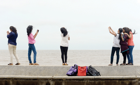 MUMBAI: Young Indian couples take ‘selfies’ on Marine Drive promenade in Mumbai. — AFP