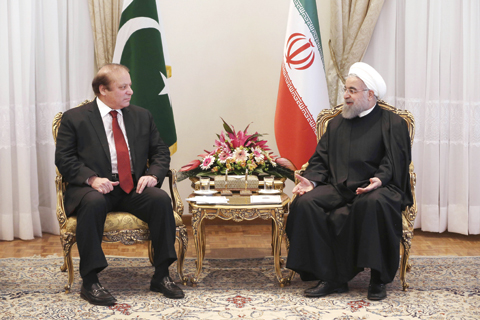 TEHRAN: Iranian President Hassan Rouhani meets Pakistani Prime Minister Nawaz Sharif yesterday. — AP
