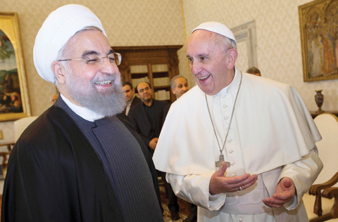 VATICAN CITY: Pope Francis (right) smiles with Iranian President Hassan Rouhani at the end of their private audience yesterday, at the Vatican. — AFP