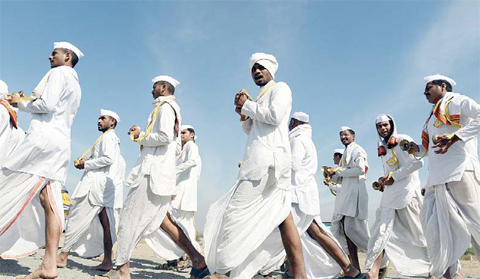 PUNE: Varkari's - Indian Hindu pilgrims who follow a religious movement within the spiritual tradition of Hinduism, sing songs as they arrive to take part in a right wing Rashtriya Swayamsevak Sangh (RSS) rally. - AFP 