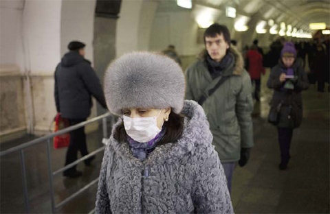 RUSSIA: A woman wearing a face mask walks in a Metro station in Moscow yesterday. — AFP