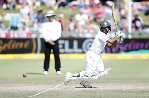 CAPE TOWN: South African batsman Temba Bavuma plays a shot during day 4 of the second Test match between England and South Africa at the Newlands stadium yesterday in Cape Town, South Africa.—AFP