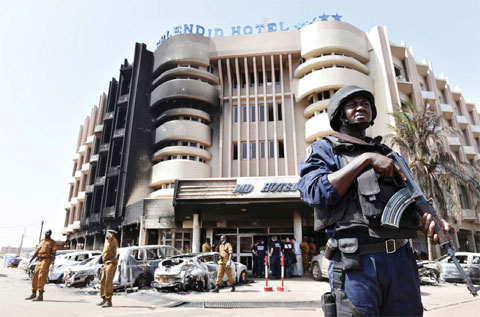 OUAGADOUGOU: A policeman stands guard in front of the Splendid hotel yesterday following a jihadist attack by Al-Qaeda linked gunmen late on January 15. —AFP