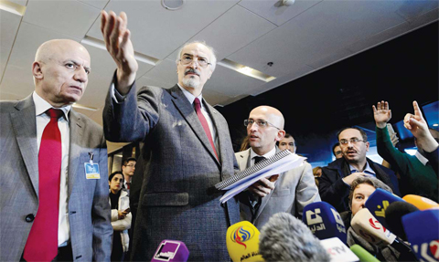 GENEVA: Syrian ambassador to UN and head of the government delegation Bashar Al-Jaafari (center) gestures as he holds a press conference during the Syria peace talks. — AFP