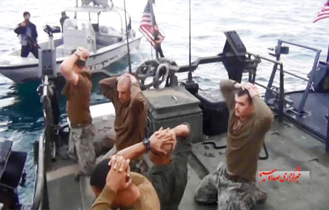 This frame grab from a video shows the detention of American Navy sailors by the Iranian Revolutionary Guards in the Arabian Gulf on Tuesday. - AP n