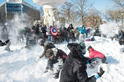 WASHINGTON: People take part in the DC Snowball Fight at Dupont Circle yesterday. Snowball fights have become a tradition after every major snowstorm in the US capital. — AFP