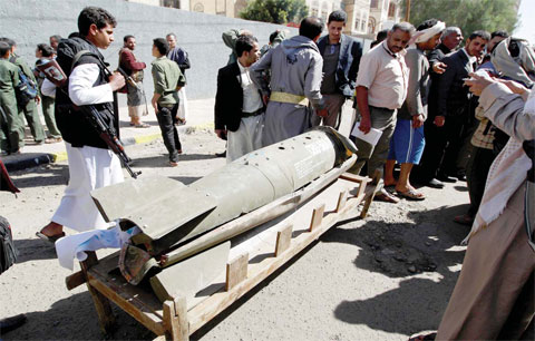SANAA: Yemenis gather around the remains of a rocket during a protest in front of the United Nations (UN) office calling for an end to the military operations carried out by the Saudi-led coalition on Yemen. — AFP