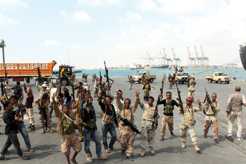 ADEN: Fighters loyal to Yemen’s President Abd-Rabbu Mansour Hadi flash the sign of victory after they managed to secure completely and take control of the port of the southern city of Aden yesterday. — AFP