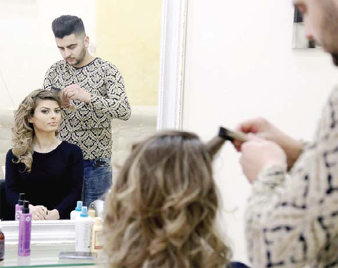 TIRANA: Presenter Greta Hoxhaj, 24 prepares prior her news edition on Zjarr TV (fire tv) in Tirana. — AFP