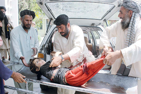 KANDAHAR: A file picture taken on July 1, 2015 shows a wounded Afghan child being brought to a hospital after being injured in a mortar explosion on July 1, 2015. —AFP