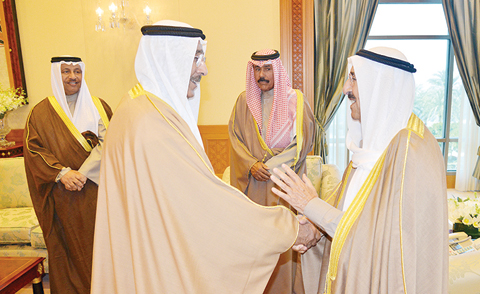 HH the Amir Sheikh Sabah Al-Ahmad Al-Jaber Al-Sabah greets reappointed Electricity and Water Minister Ahmad Al-Jassar after he was sworn in