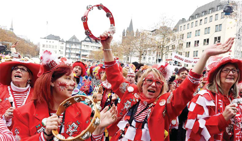 COLOGNE: File photo shows carnival revelers celebrating the launch of the so-called “Fifth Season”, the carnival season in Cologne, western Germany. —AFP