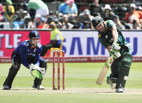 PORT ELIZABETH: South Africa's A.B. De Villiers, right, at the wicket with England's Jos Butler keeps wicket, left, during the second One Day International cricket match in Port Elizabeth, South Africa, yesterday. - AP