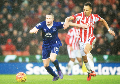 STOKE-ON-TRENT: Everton's Tom Cleverley, left, and Stoke City's Peter Odemwingie battle for the ball during the English Premier League match at the Britannia Stadium, Stoke-on-Trent yesterday. - AP
