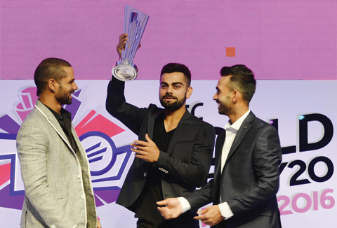 A file picture taken on December 11, 2015 shows Indian cricketers Shikhar Dhawan (L) and Ajinkya Rahane (R) smiling as captain Virat Kohli jokingly holds aloft the ICC World Twenty20 India 2016 trophy during an event to announce the groups and schedule in Mumbai.
