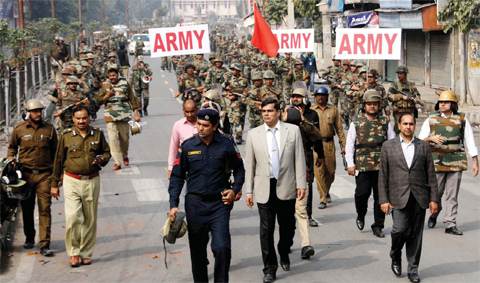 ROHTAK: Indian Army and security personnel patrol following fatal caste protests in Rohtak yesterday. — AFP